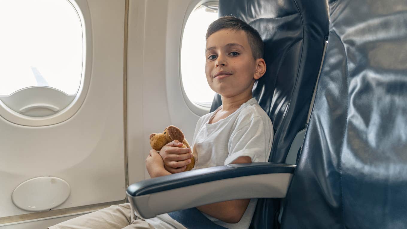 Boy sitting alone on plane