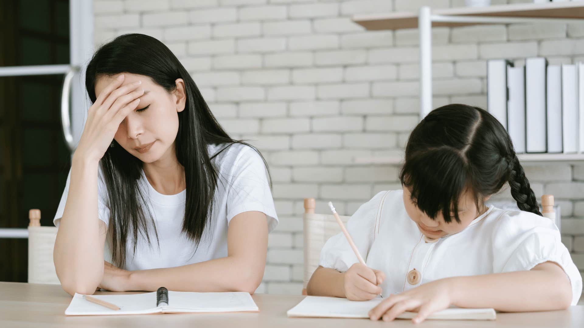 mother helping daughter with homework