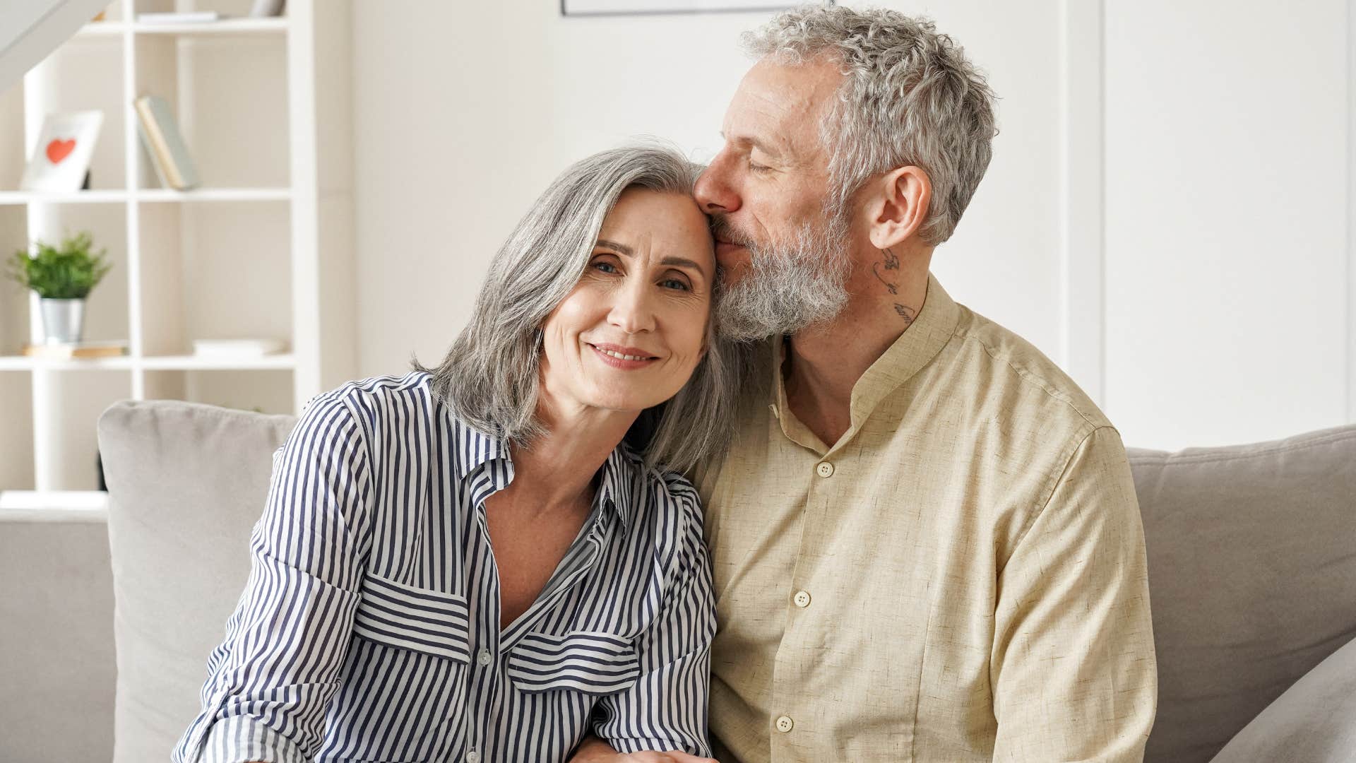 Adult couple smiling and hugging.