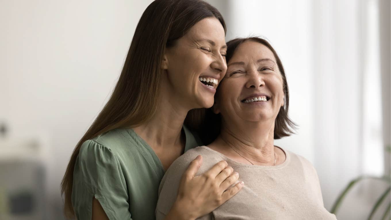 Mother and her daughter hugging and smiling.