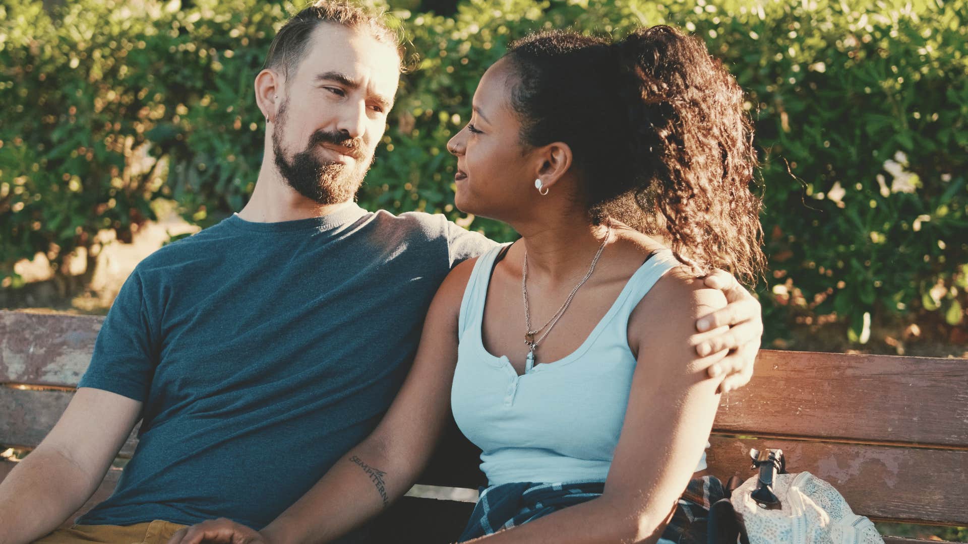 couple sitting on a bench talking