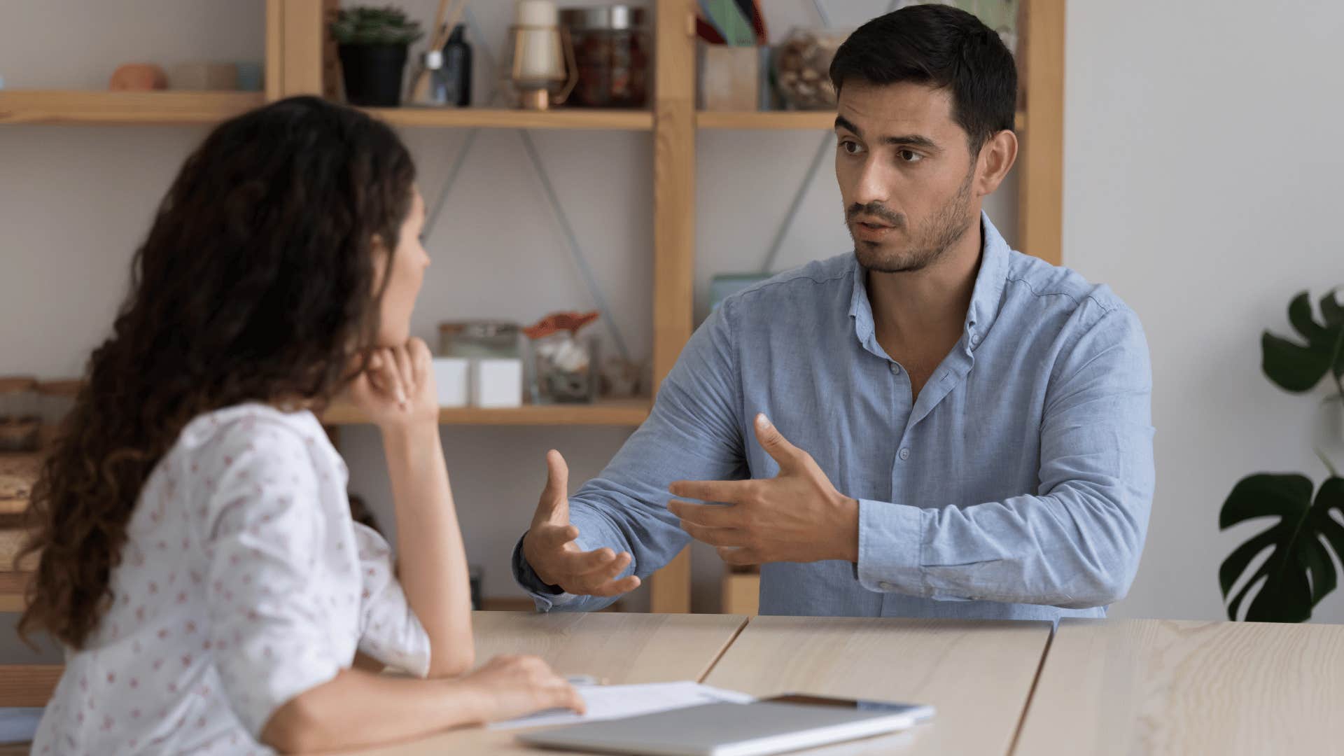 man explaining something to woman