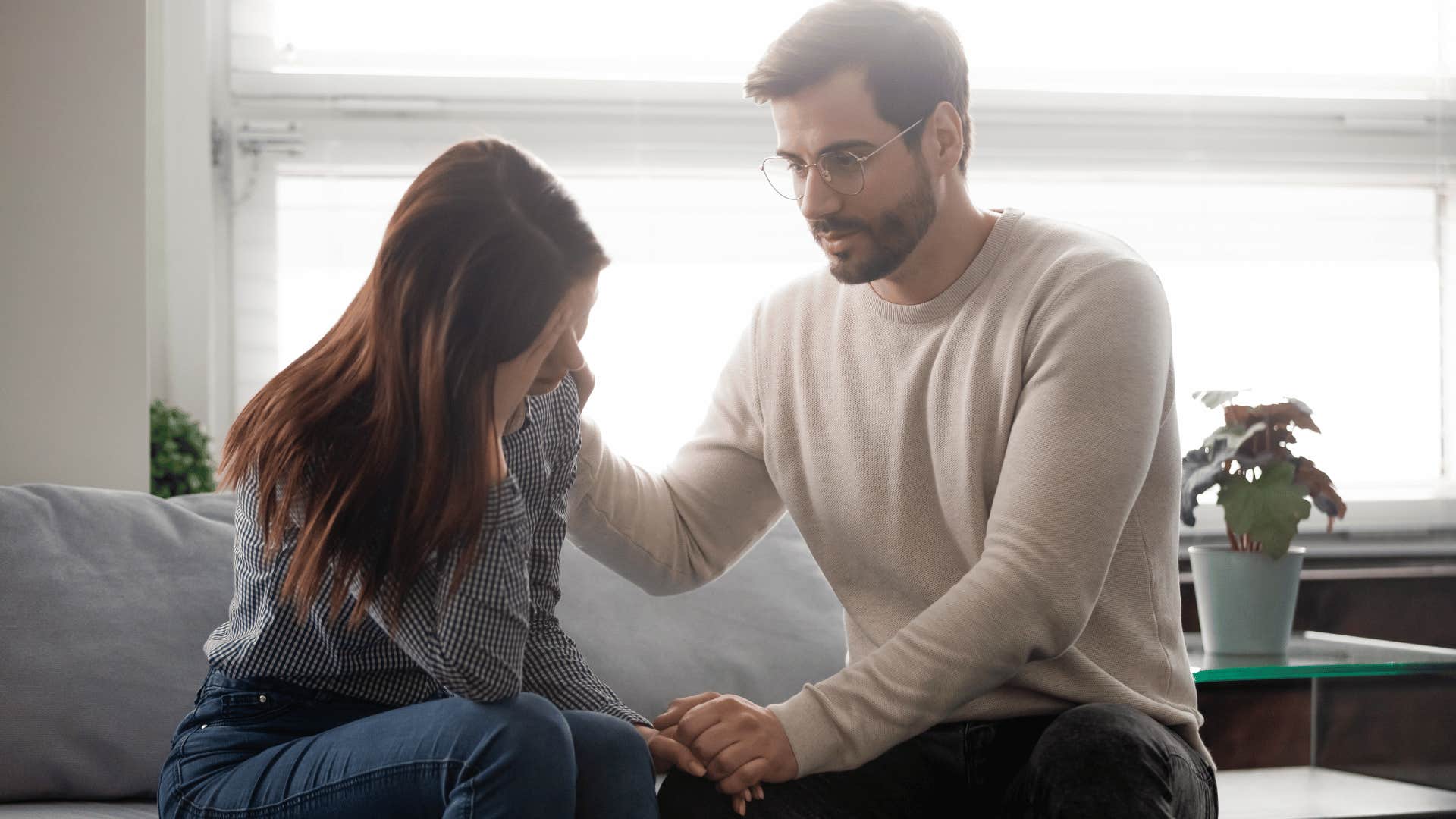 man comforting crying woman