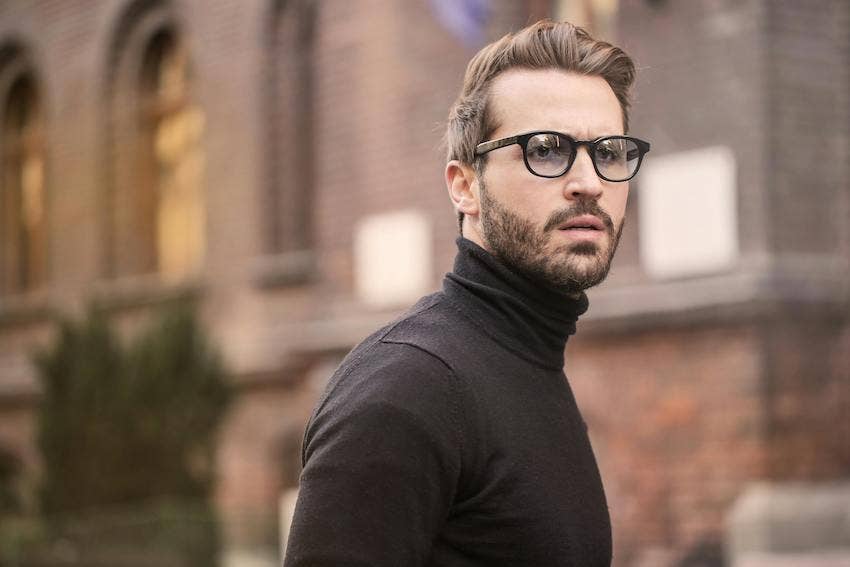 Pensive Man in Glasses Wearing a Black Turtleneck on YourTango 