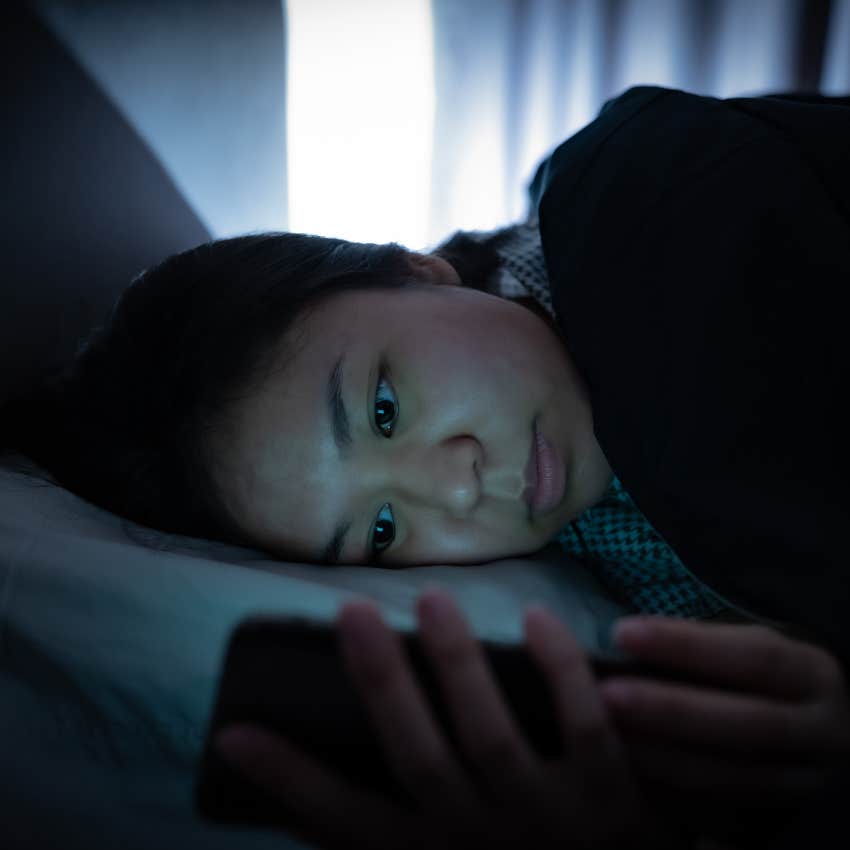 Woman on her phone before bed