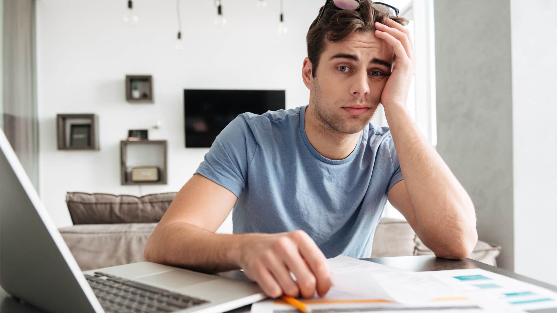 Tired and sick worker looking upset at his desk.