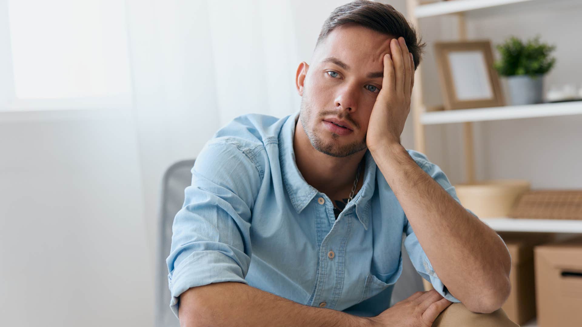 Man looking annoyed sitting in a chair