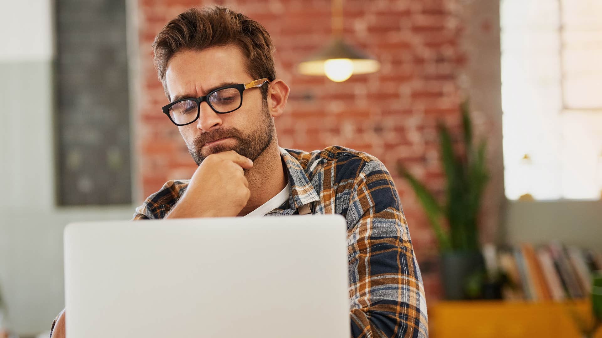 Man looking confused staring at his laptop