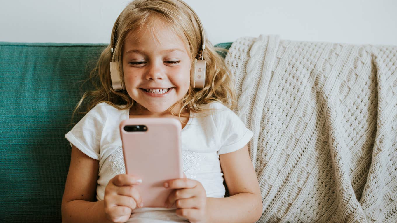 Young girl smiling because she'll never hear these phrases 80s parents said