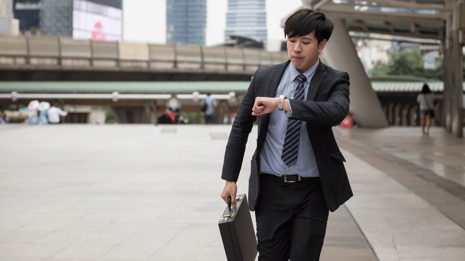 man running late checking watch