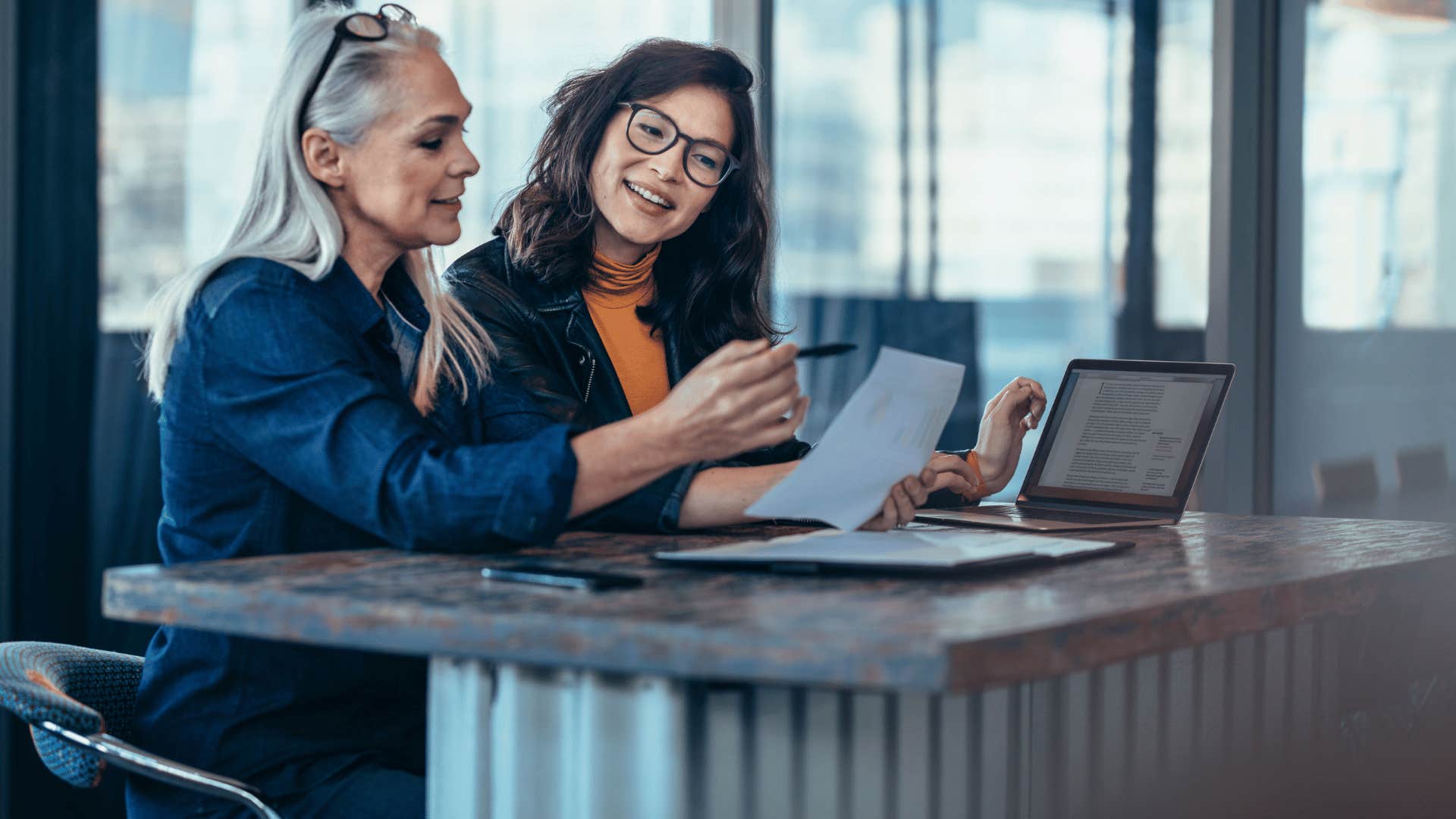 two coworkers looking at paperwork