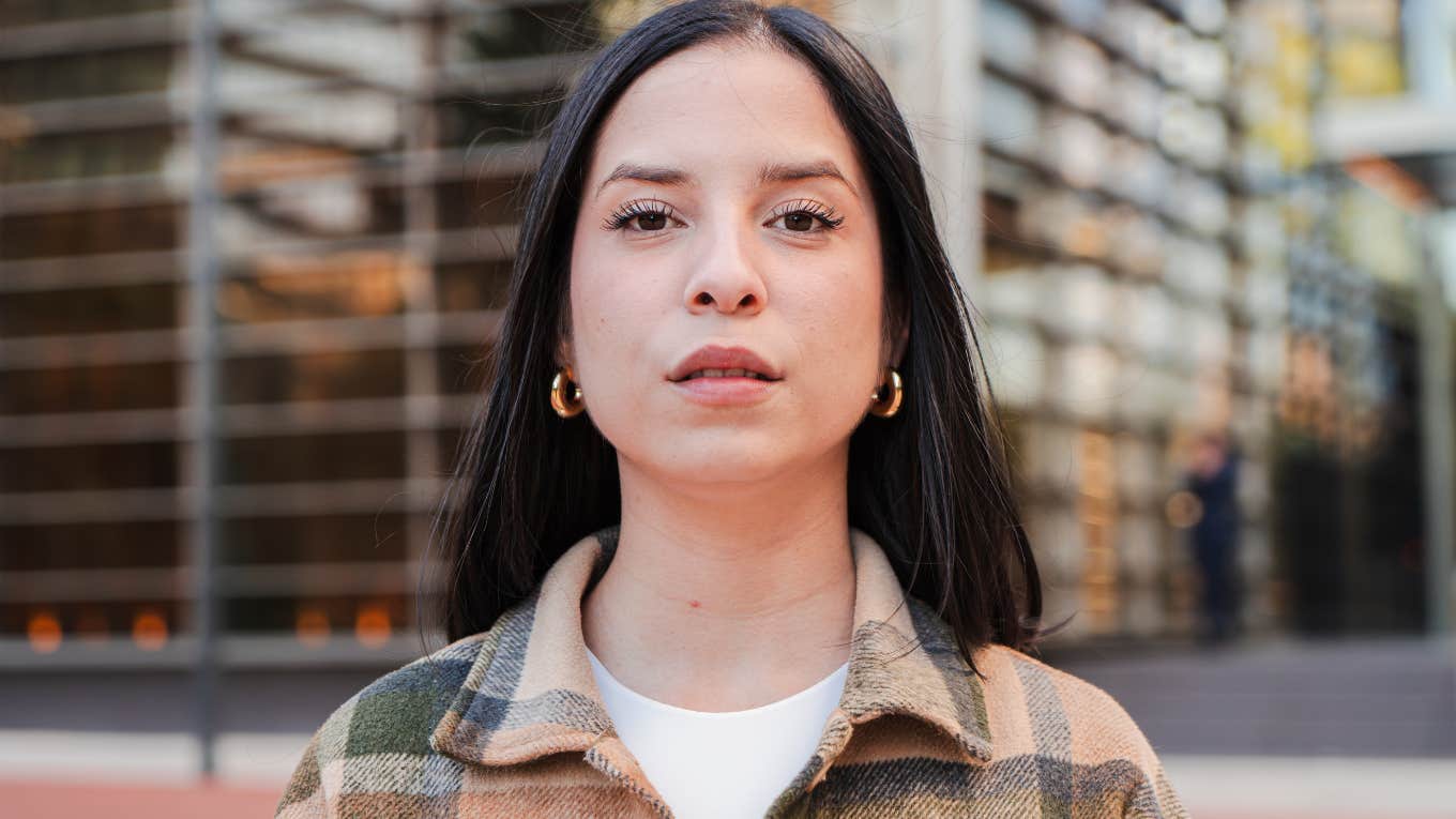 serious woman in a flannel jacket