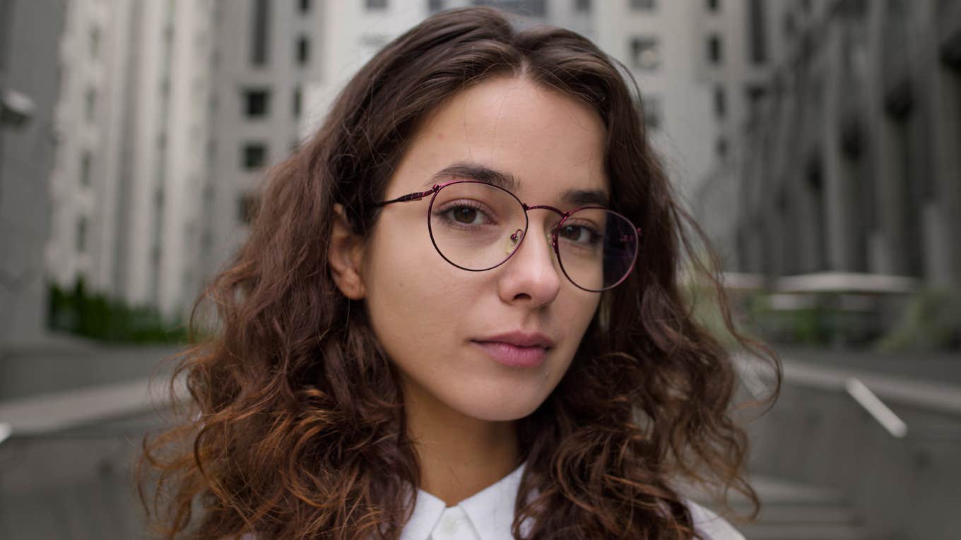 woman with glasses staring ahead