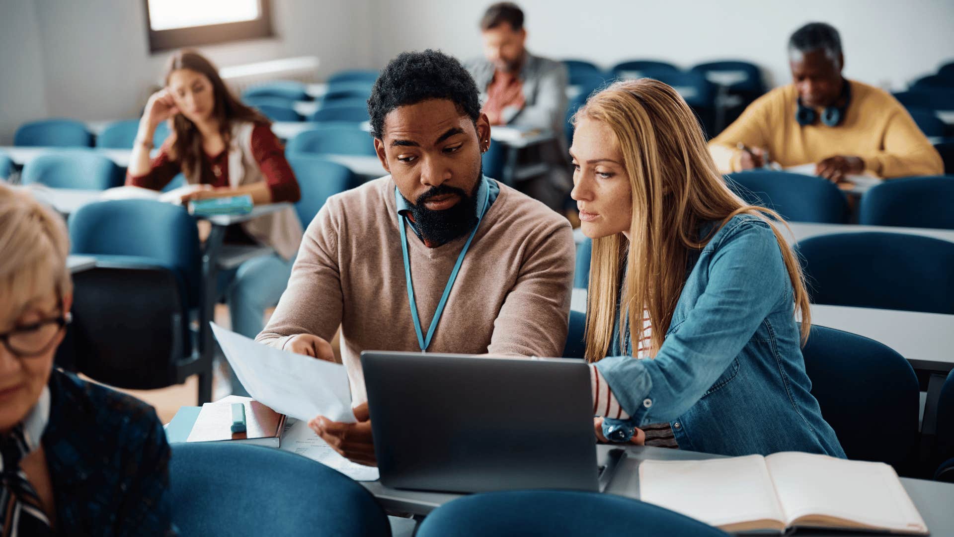 woman helping man in class