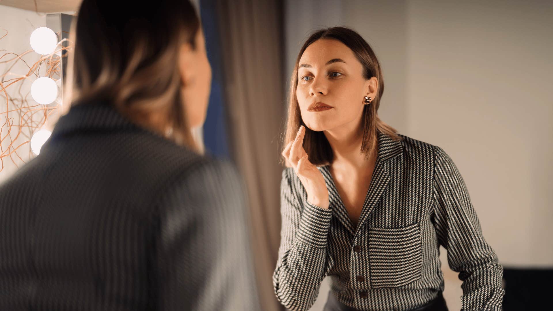 woman looking in mirror