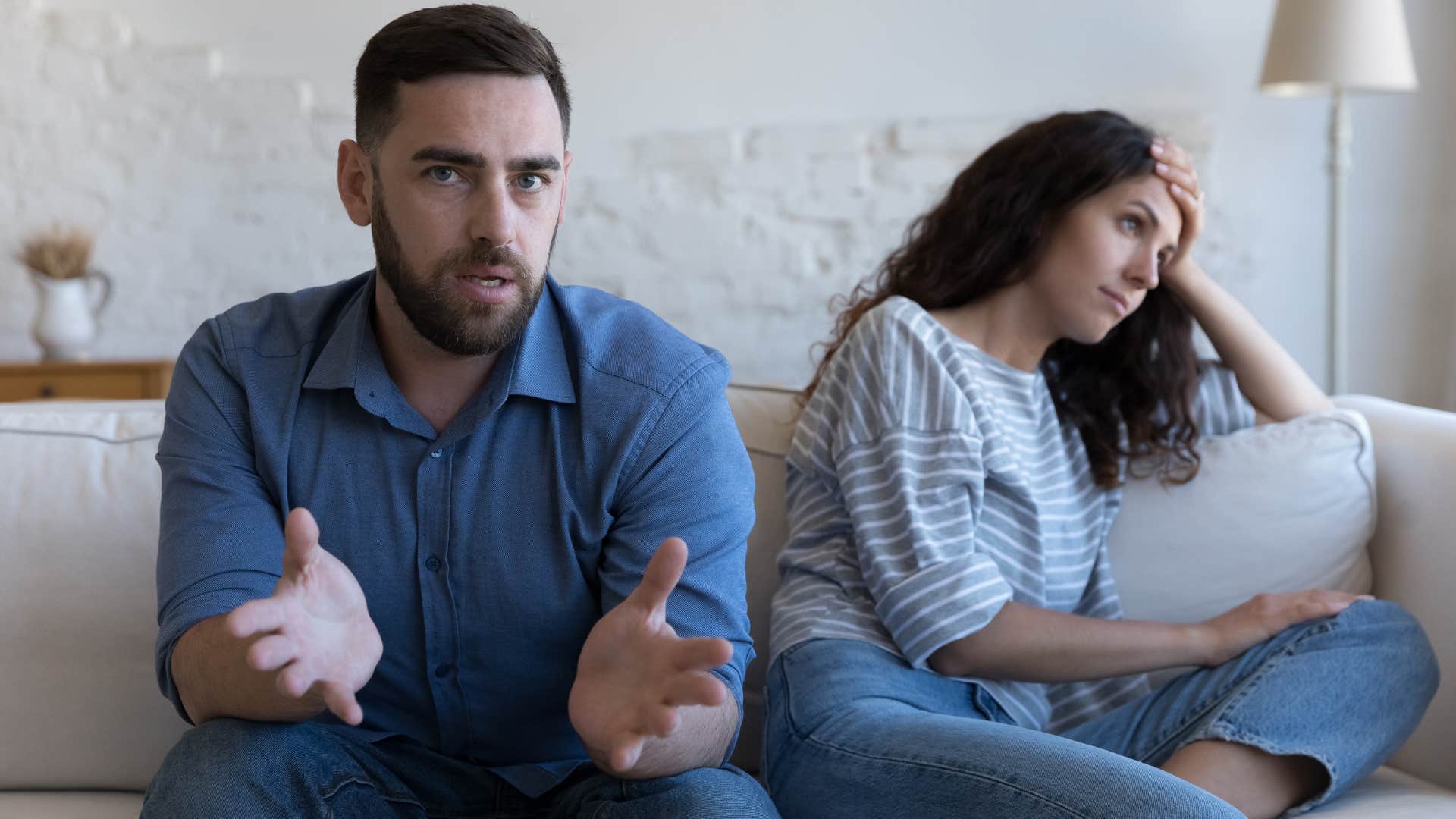 Man looking confused while his partner sits next to him.