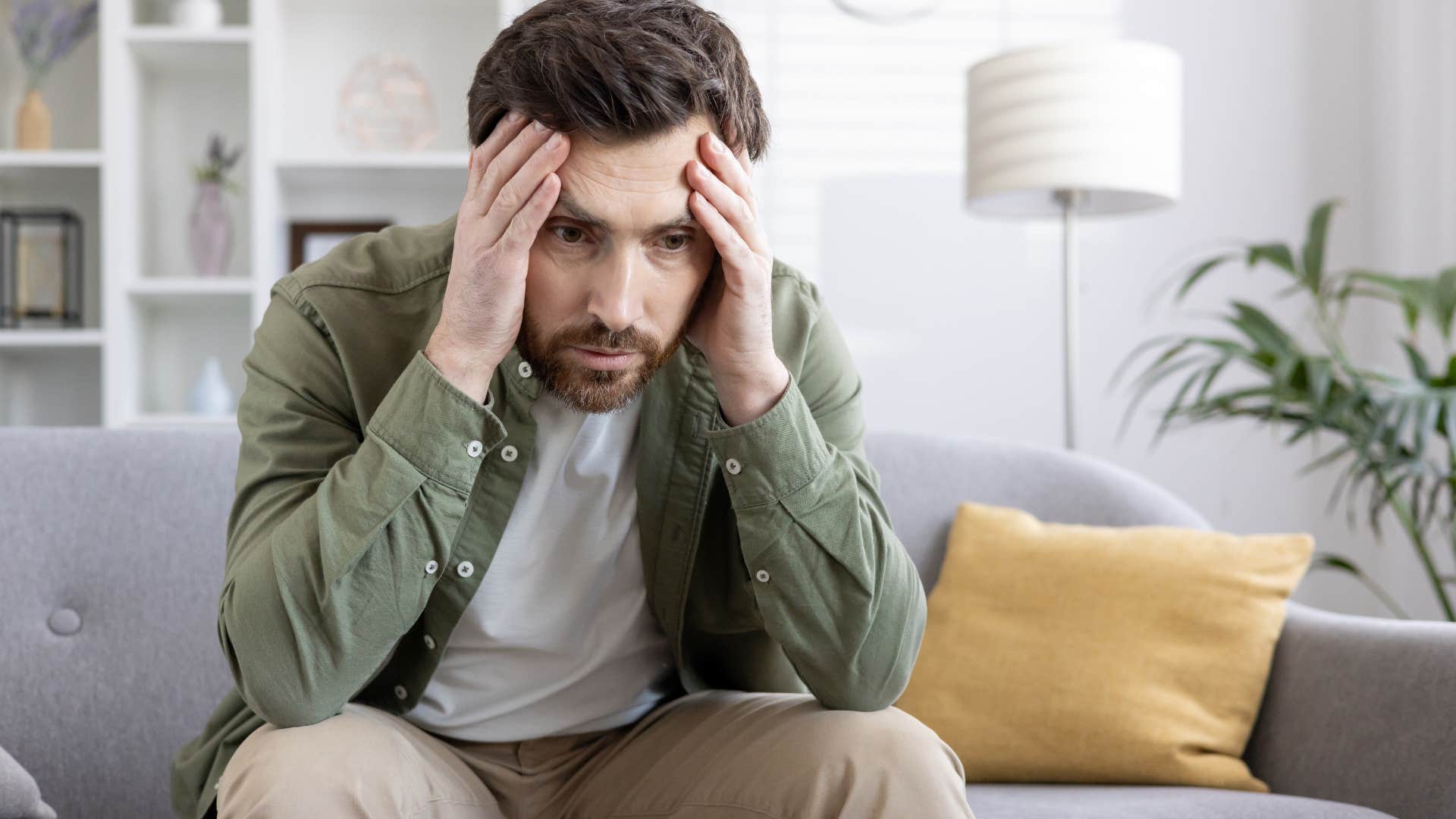 Man looking upset and lonely at home.