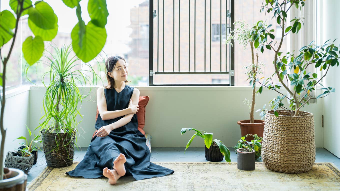 Woman with plants inside of her home