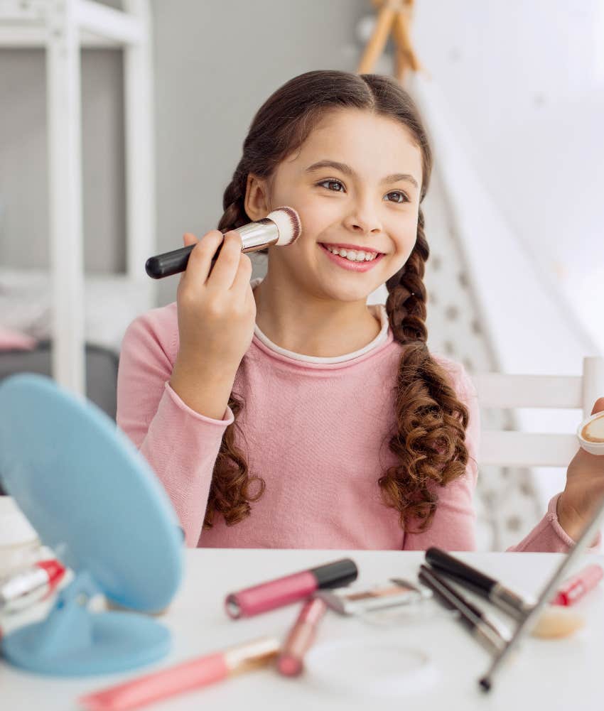 Pre-teen girl putting on makeup