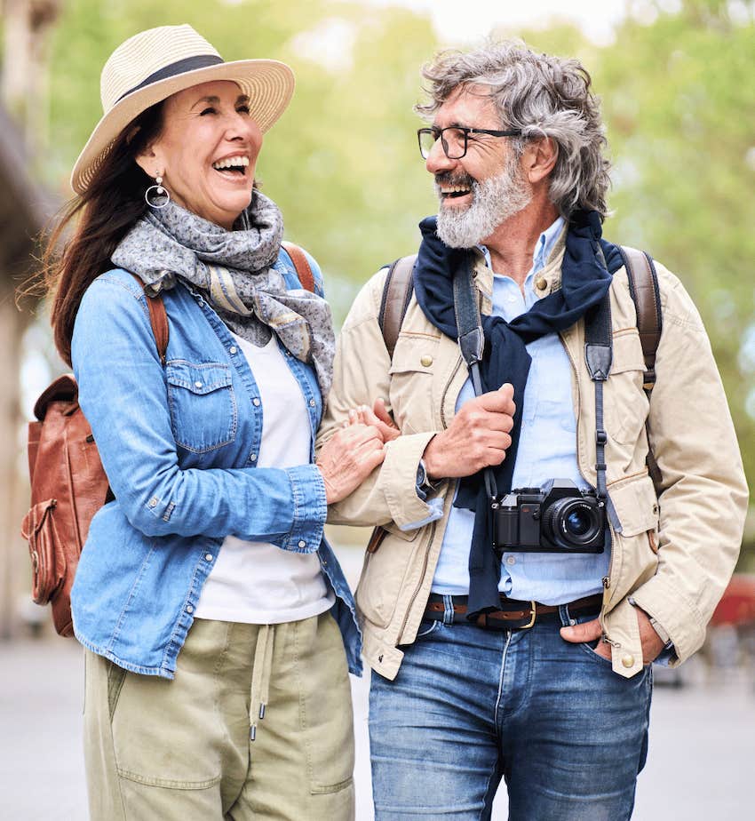 Couple walk down sidewalk happily