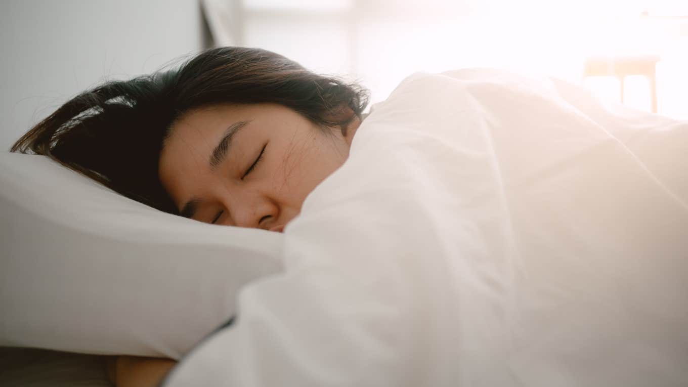 close up shot of woman sleeping in bed