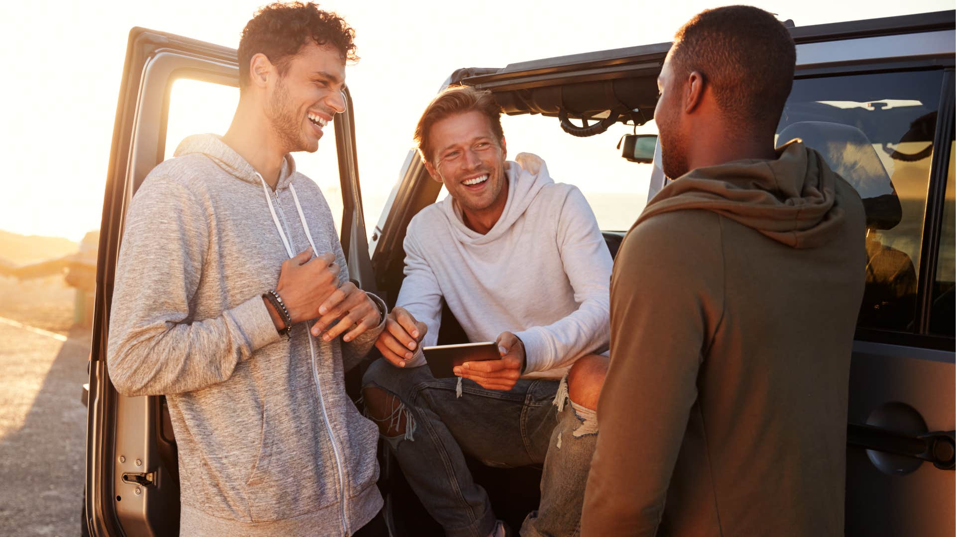 Male friends hanging out at the beach.