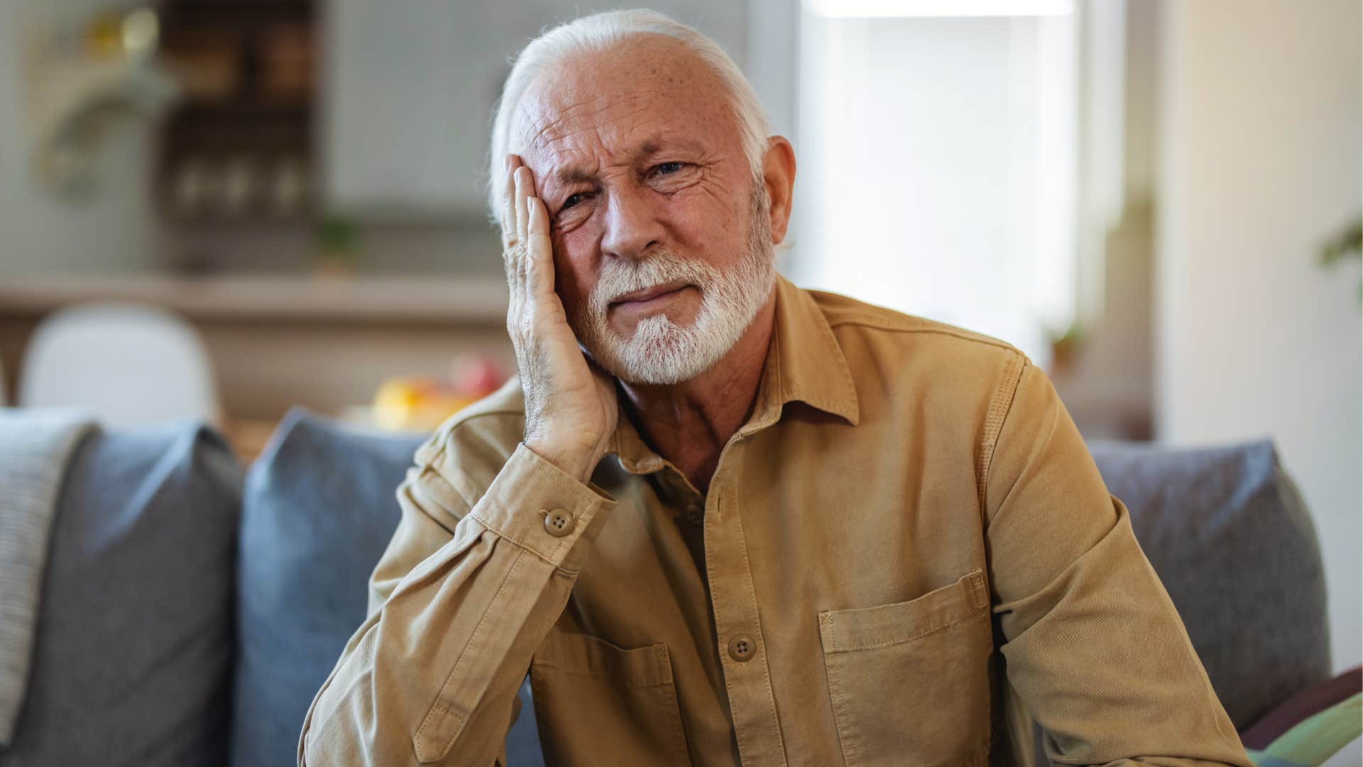 Man holding his head and looking upset.