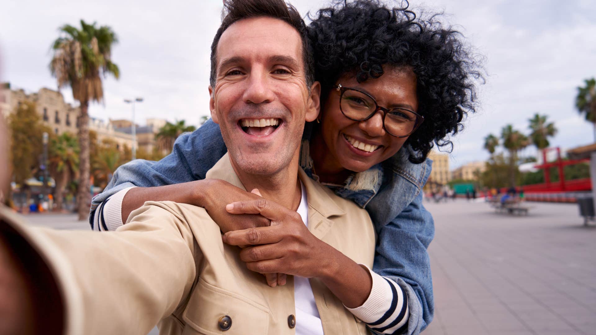 Man and woman looking happy taking a picture