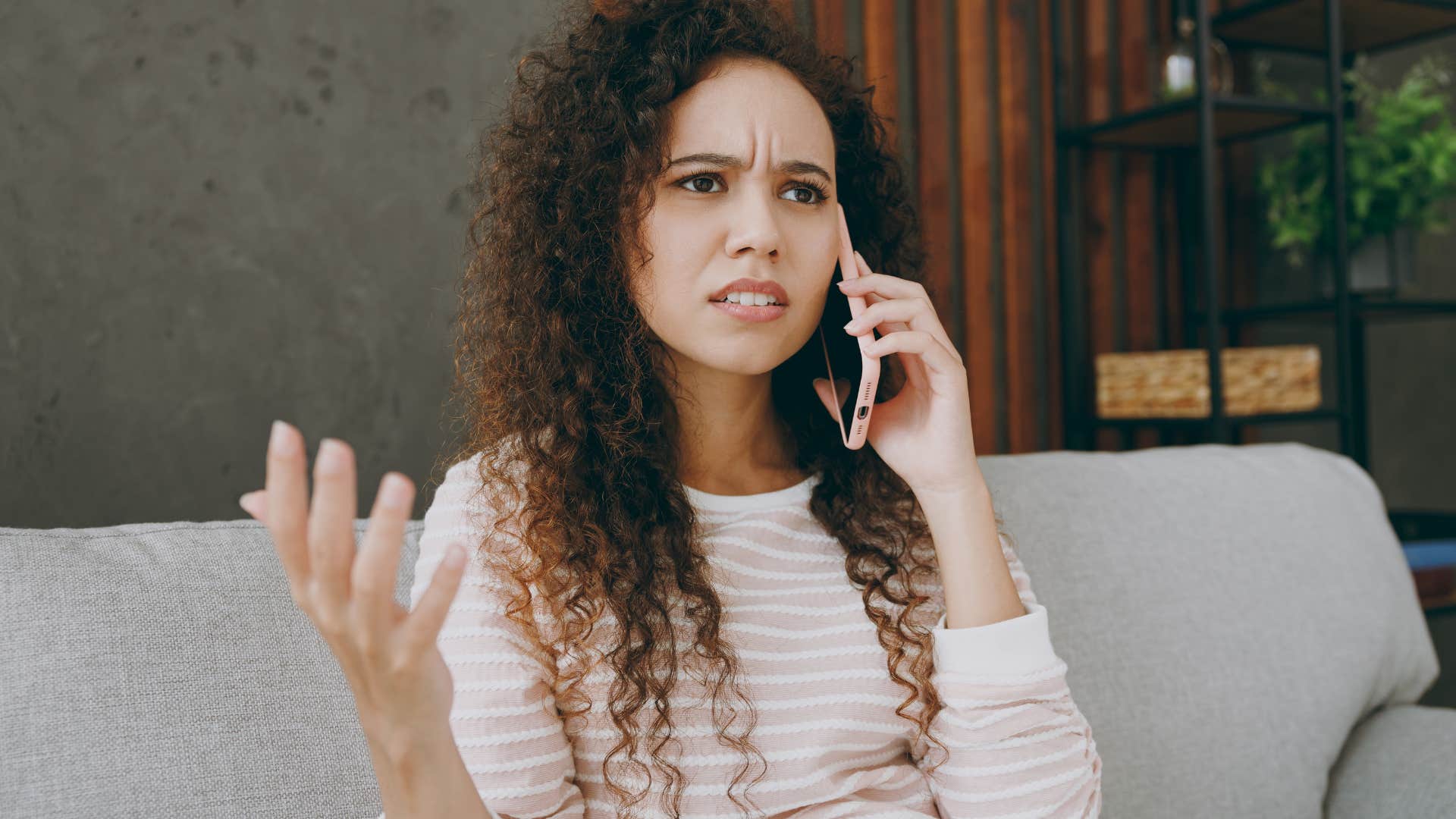 Woman looking frustrated on a phone call