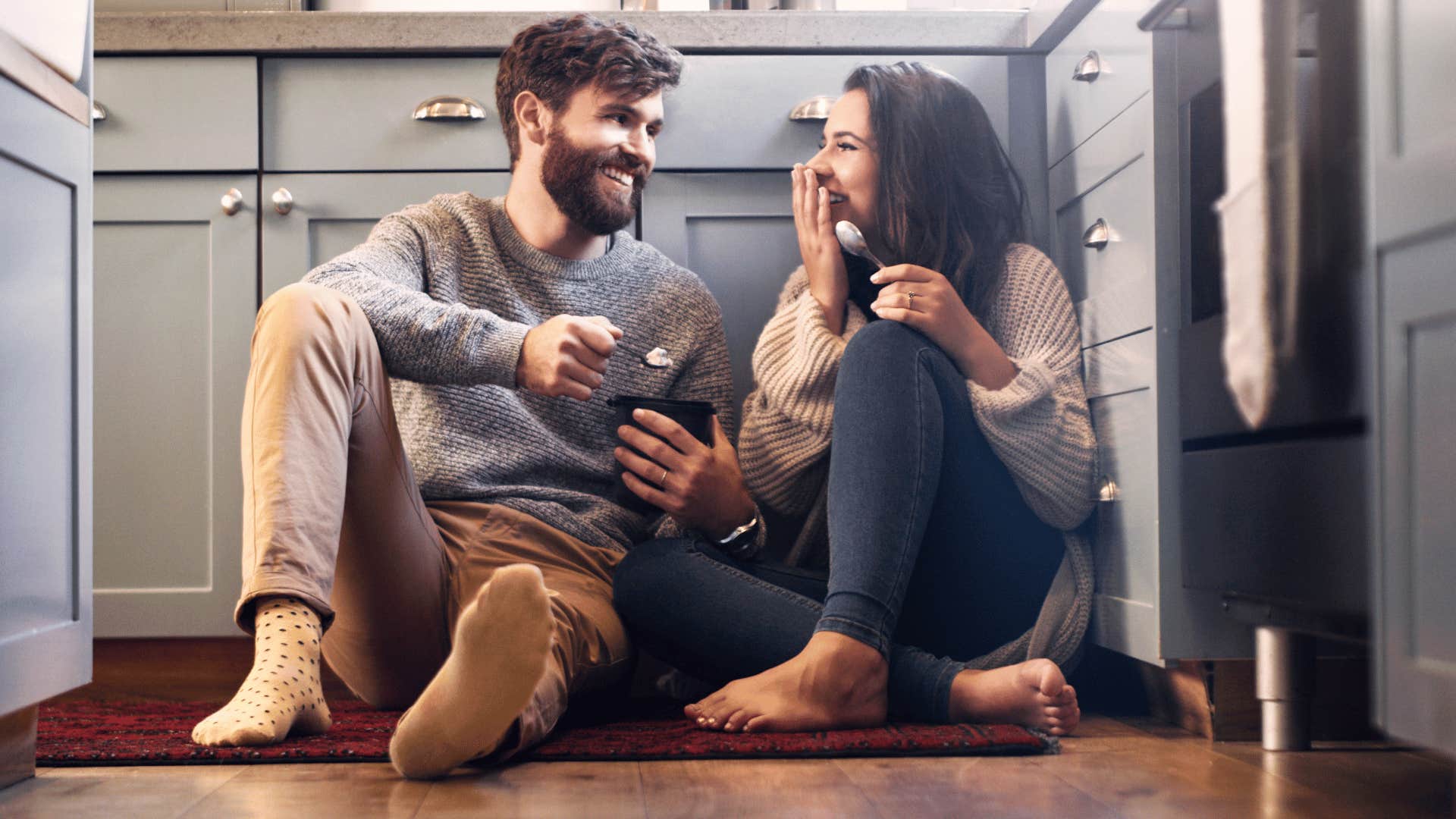 couple eating ice cream on kitchen floor