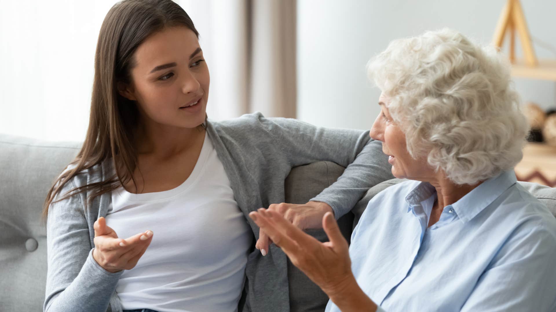 Adult woman looking frustrated while her mother talks.