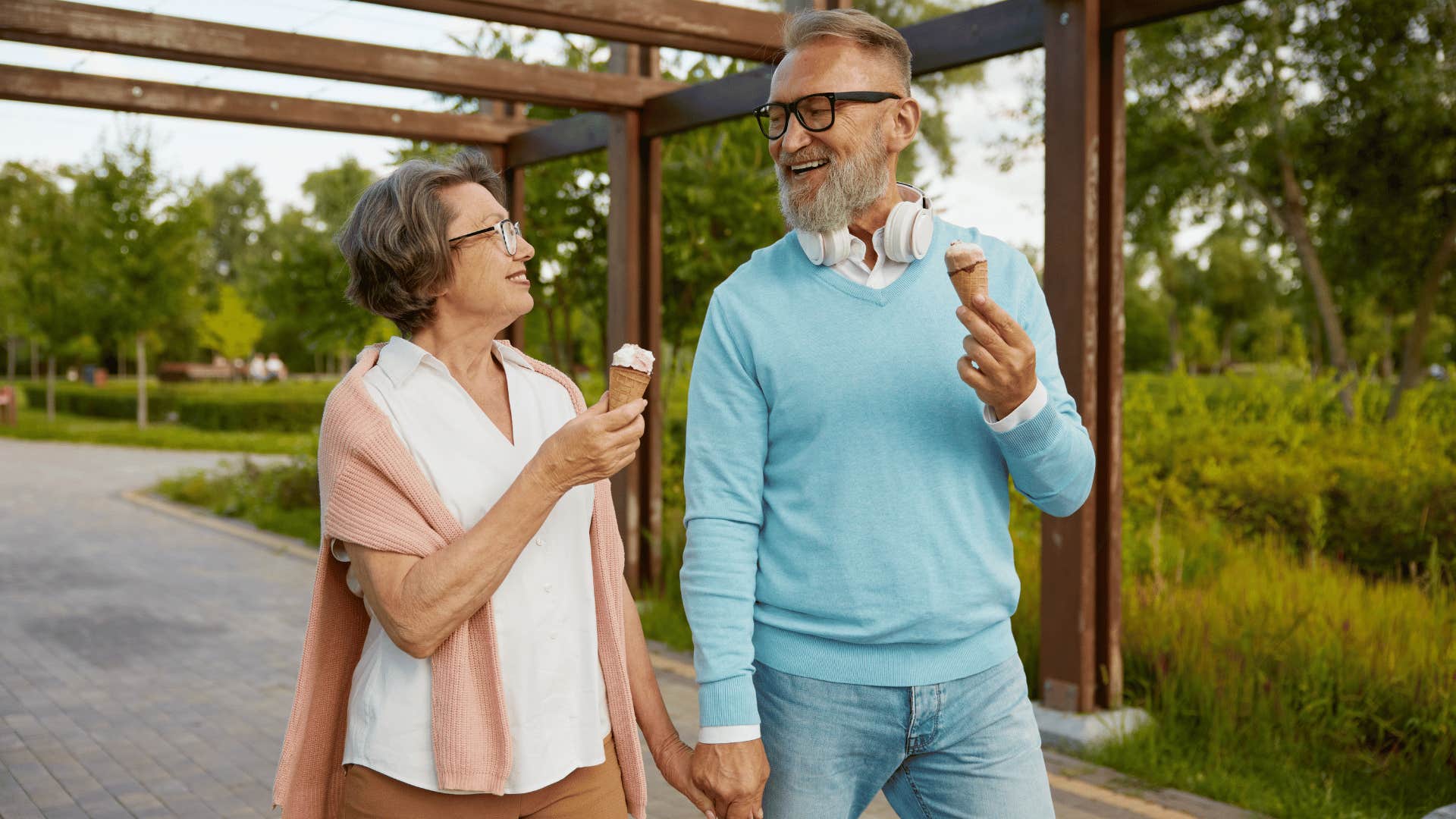 older couple holding hands and eating ice cream