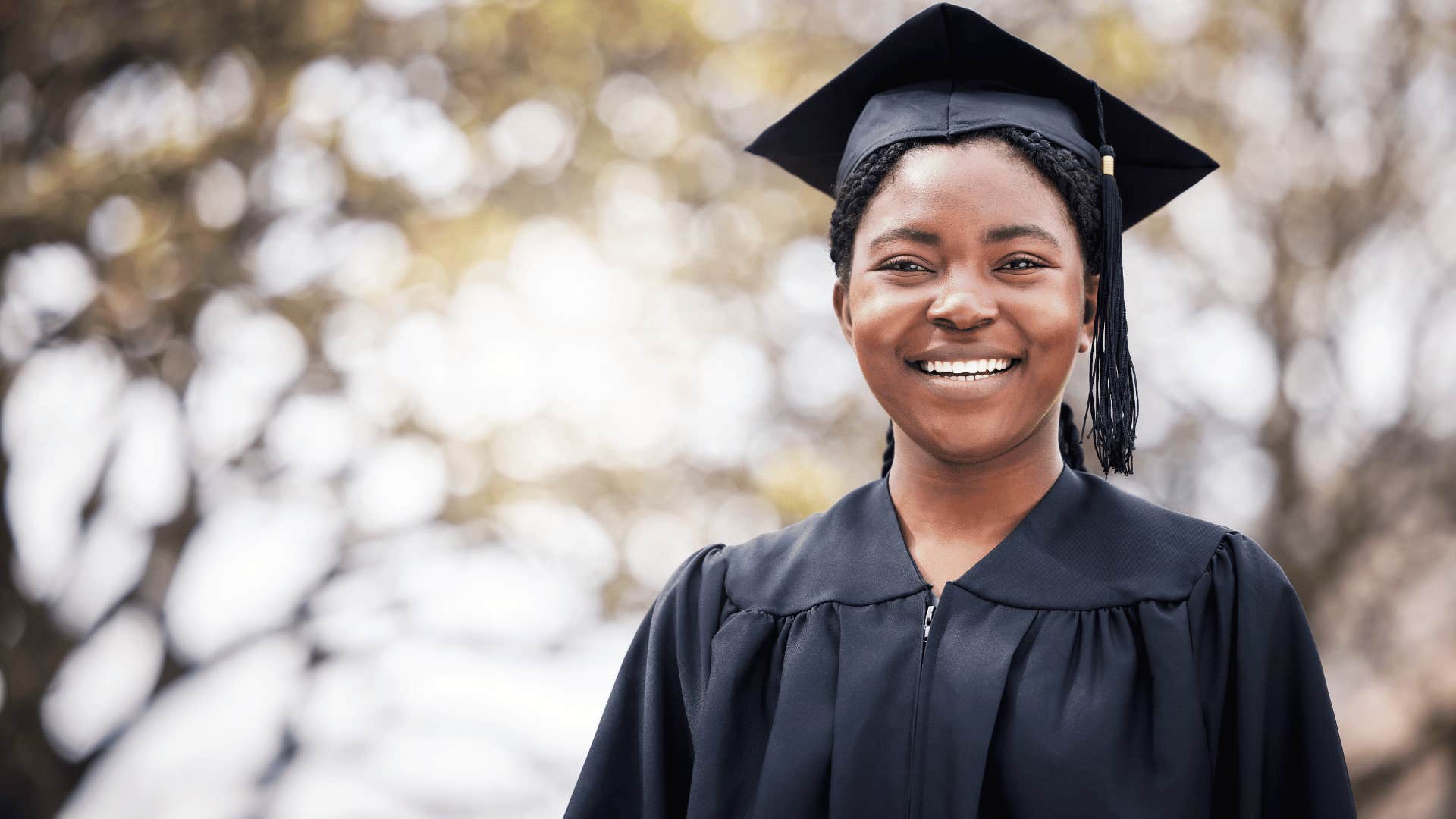 woman in graduation robes smiling 