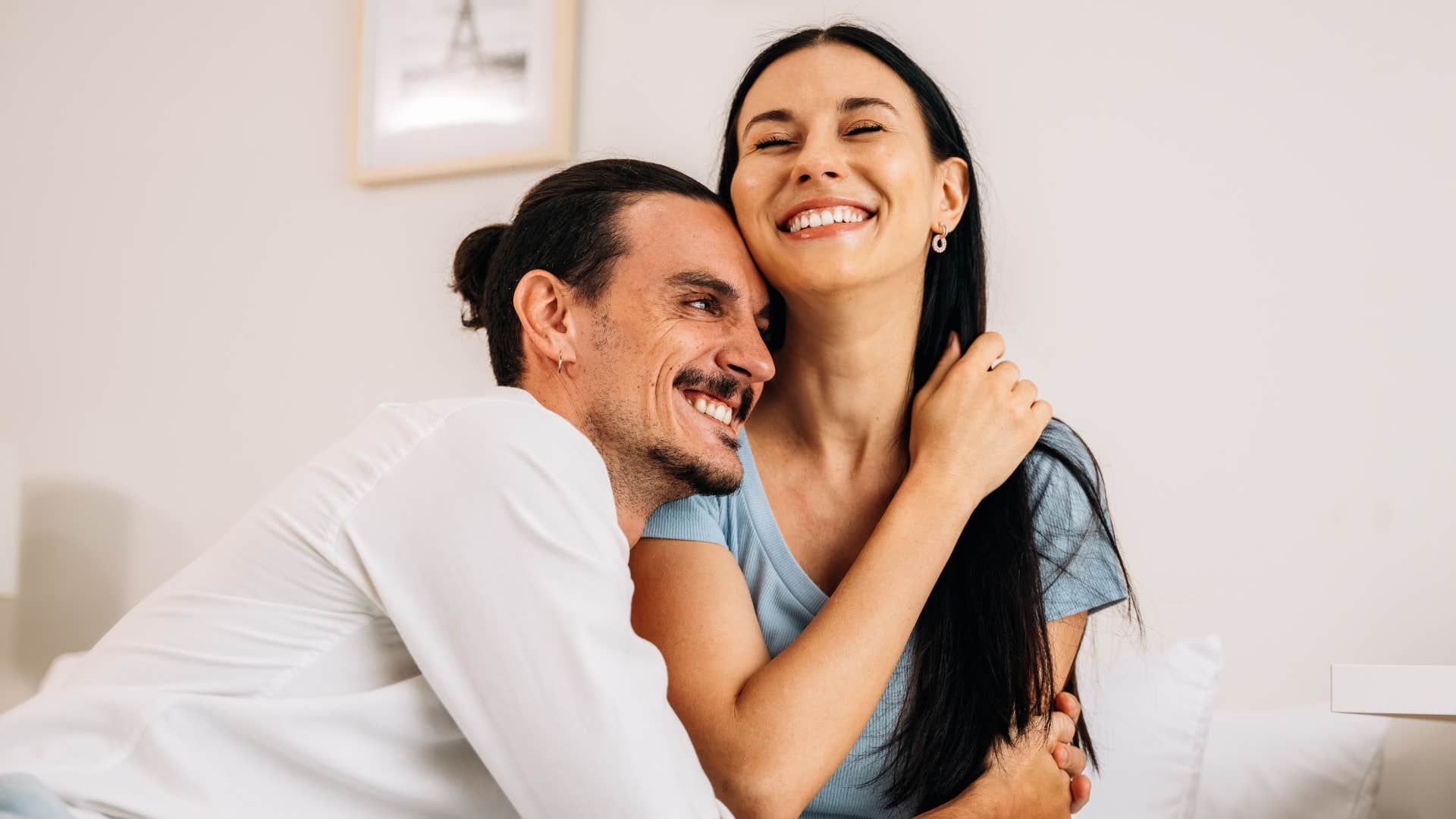 Healthy couple smiling and hugging each other. 