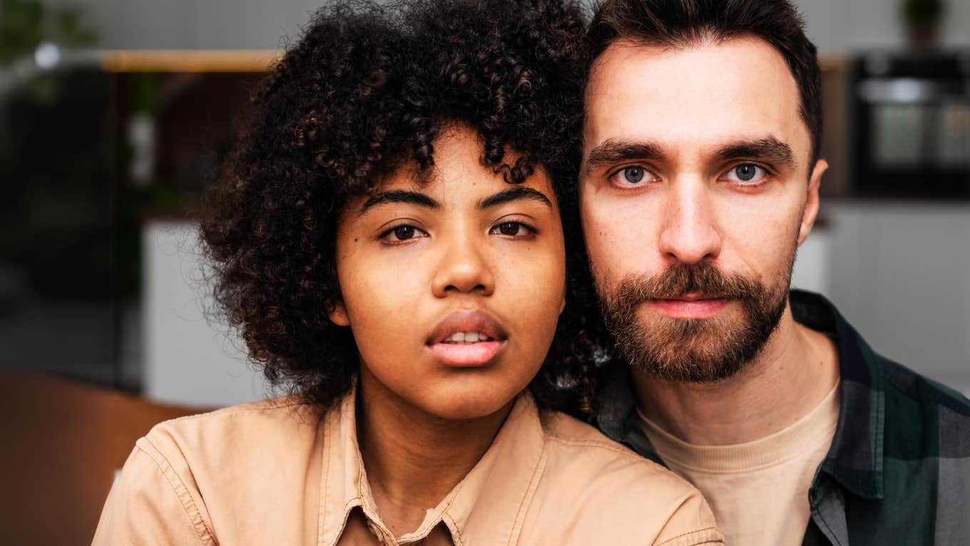 Couple in relationship that survived cheating, sitting next to each other.