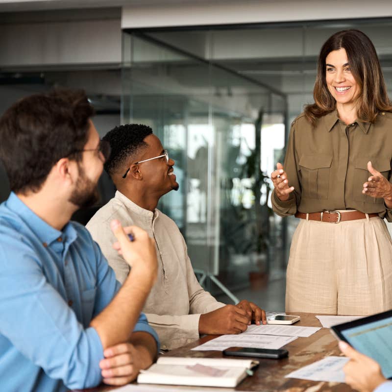 boss having meeting with employees in office