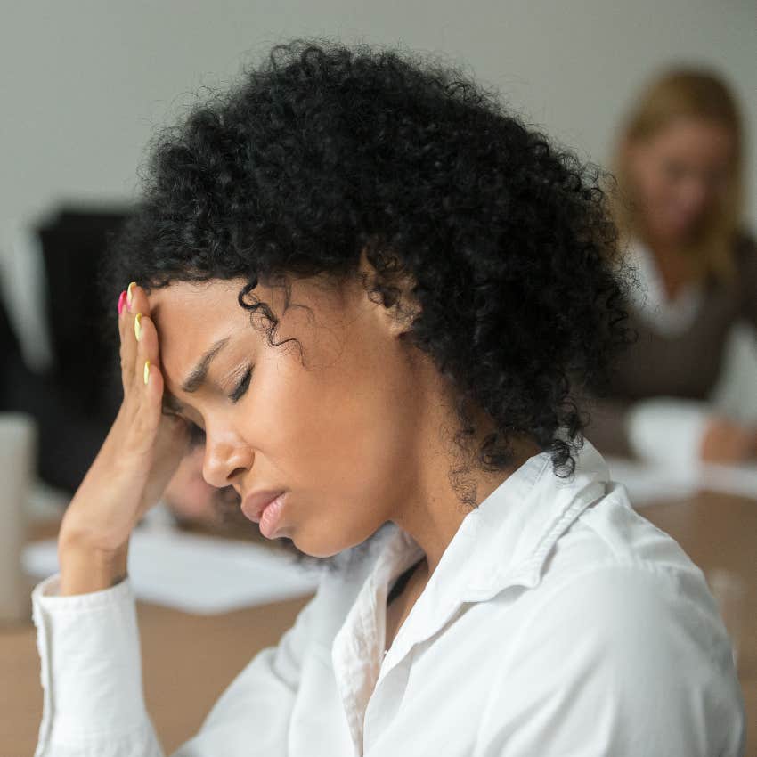 Sad woman in work meeting