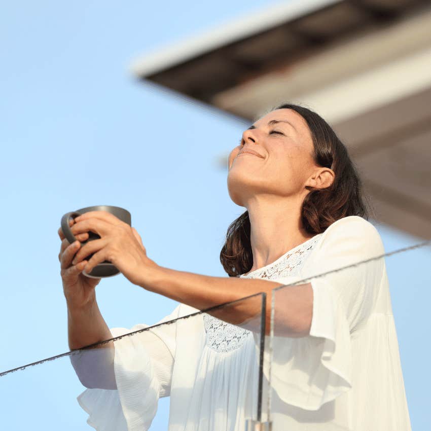 satisfied woman breathing in fresh air