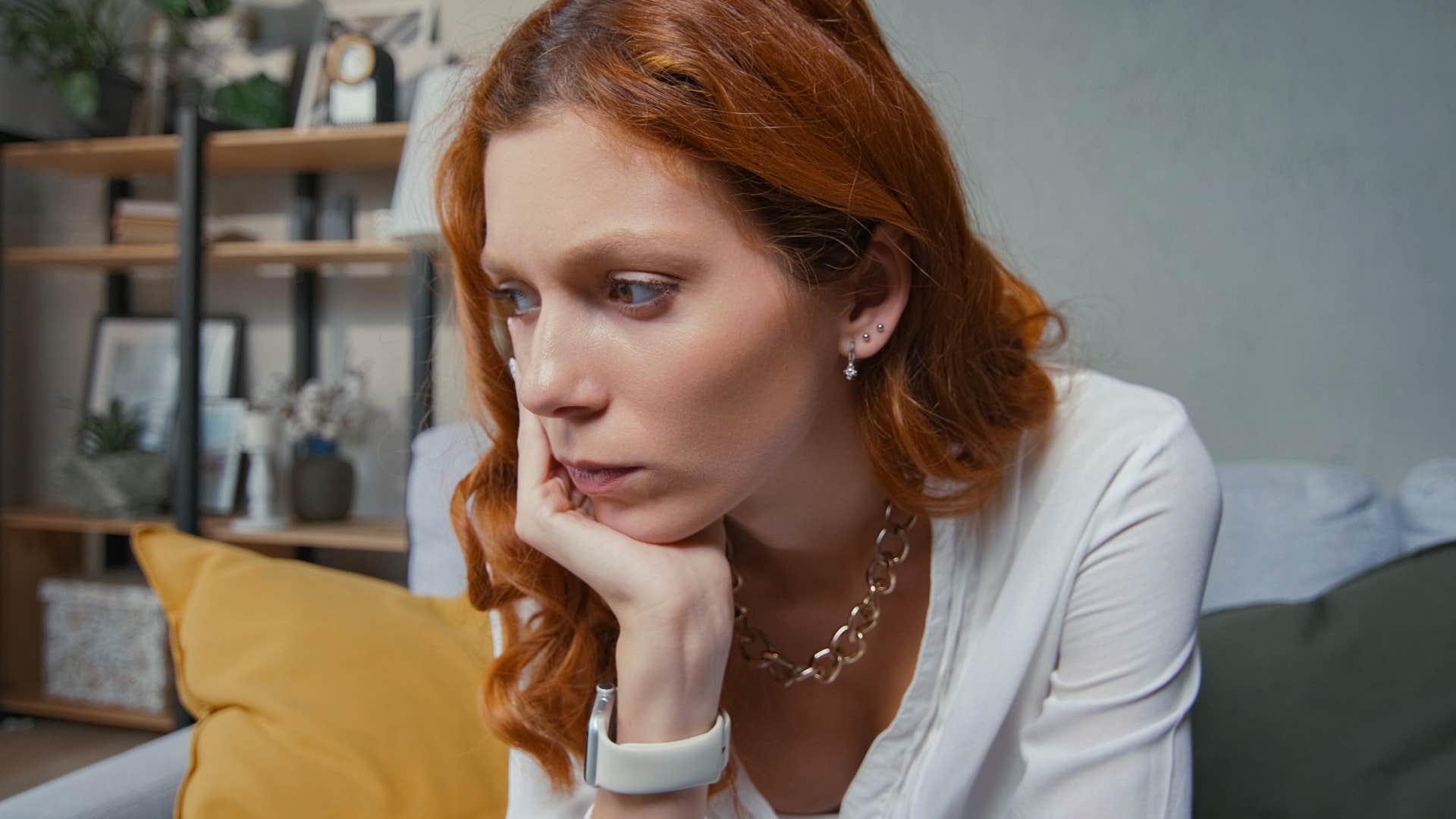 Woman looking frustrated and upset on the couch. 