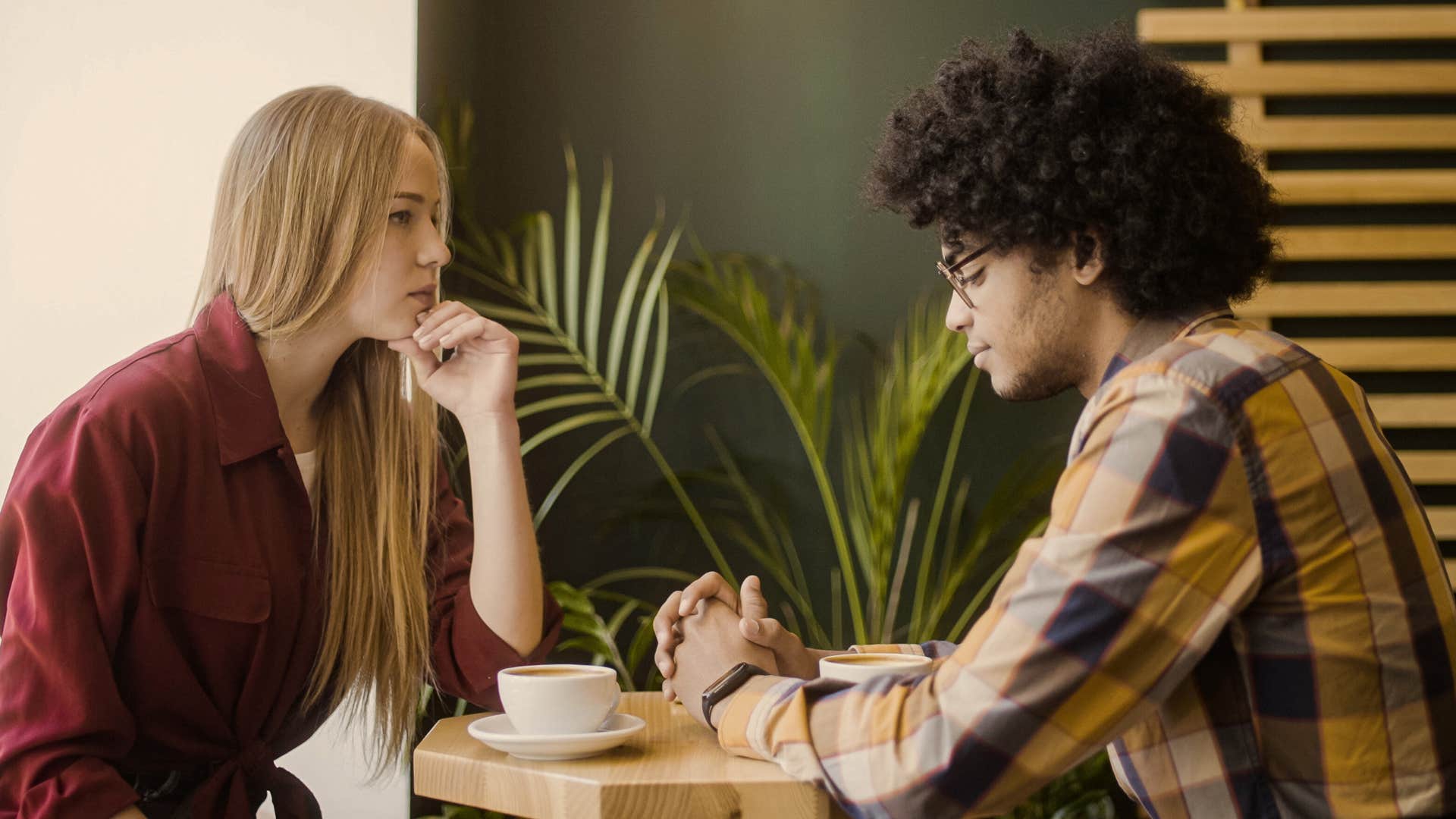 Serious conversation between a couple at a coffee shop. 