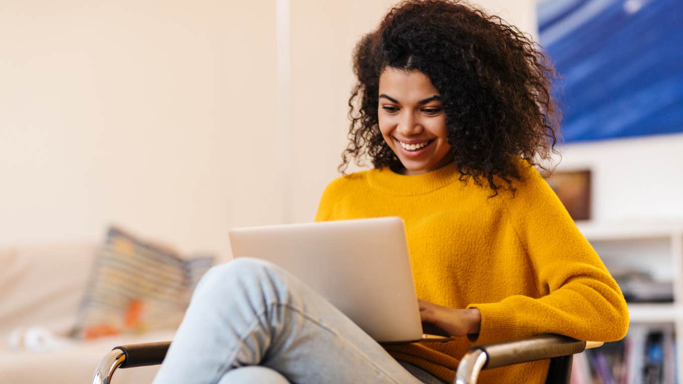 woman sitting in her home working on laptop