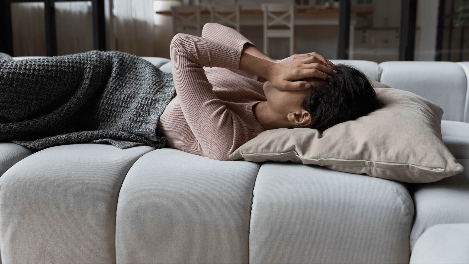 woman lying on couch 