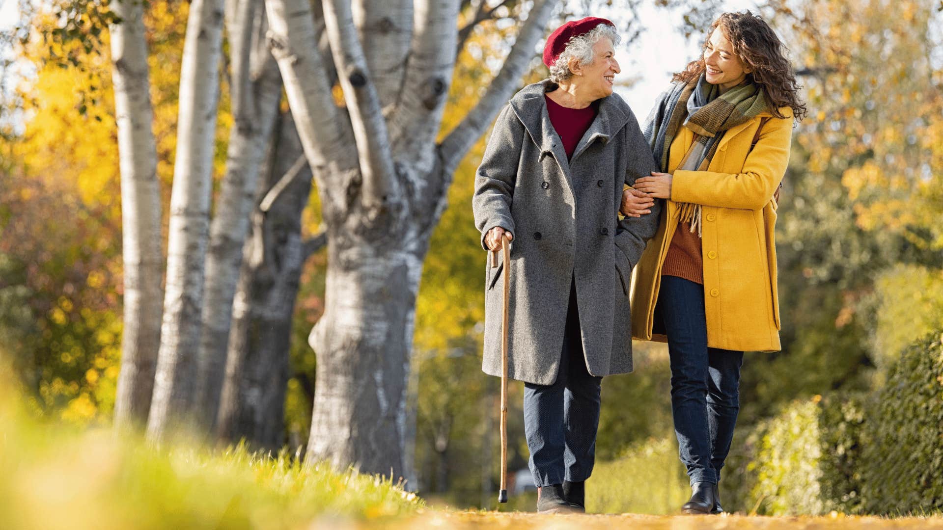 younger woman walking and chatting with older woman