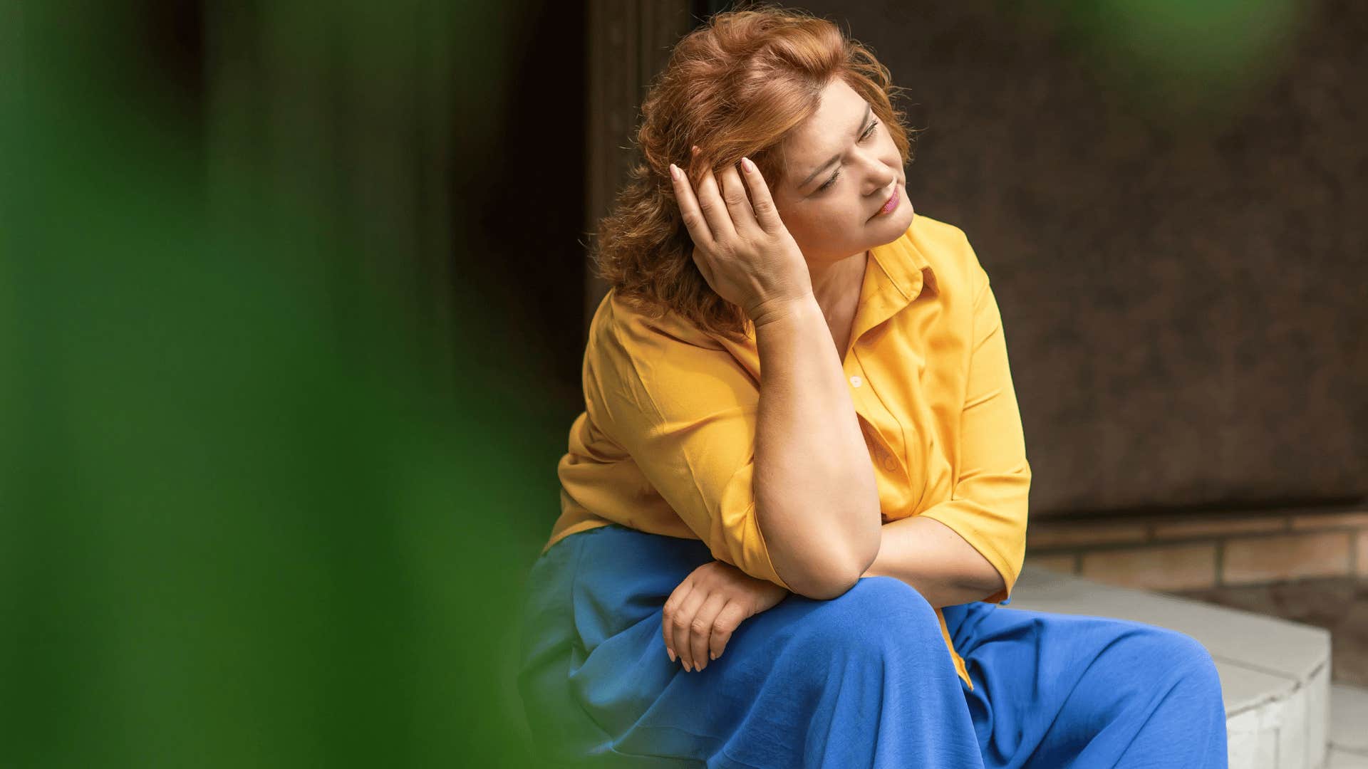 woman sitting down looking upset 