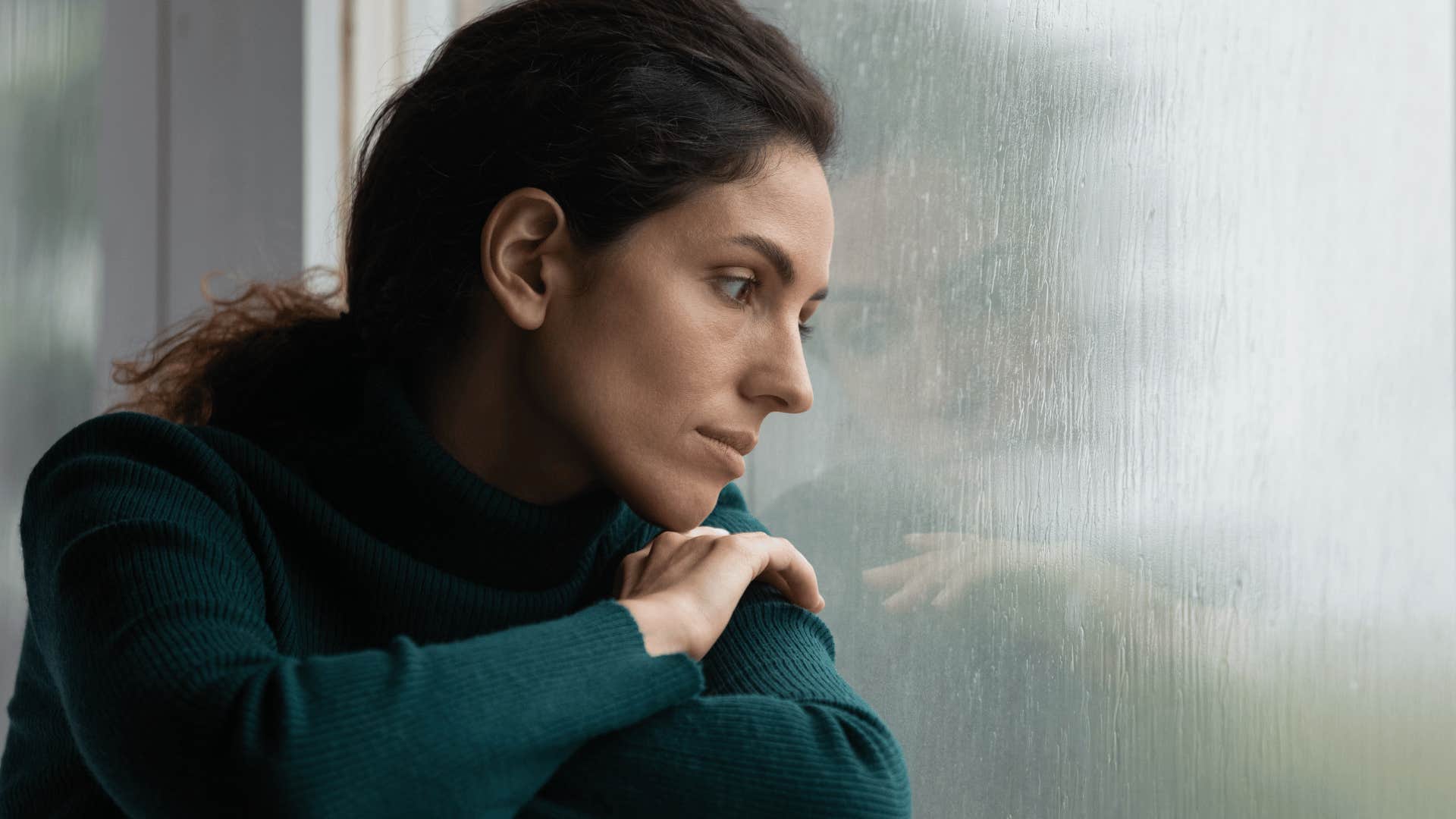 woman looking out a window