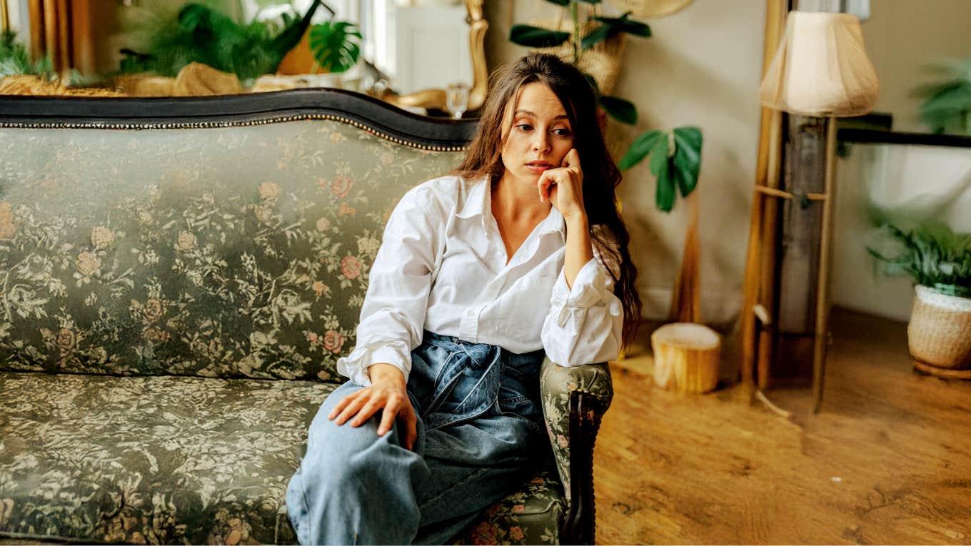 Woman reflecting on her families dysfunction while sitting in parents home 