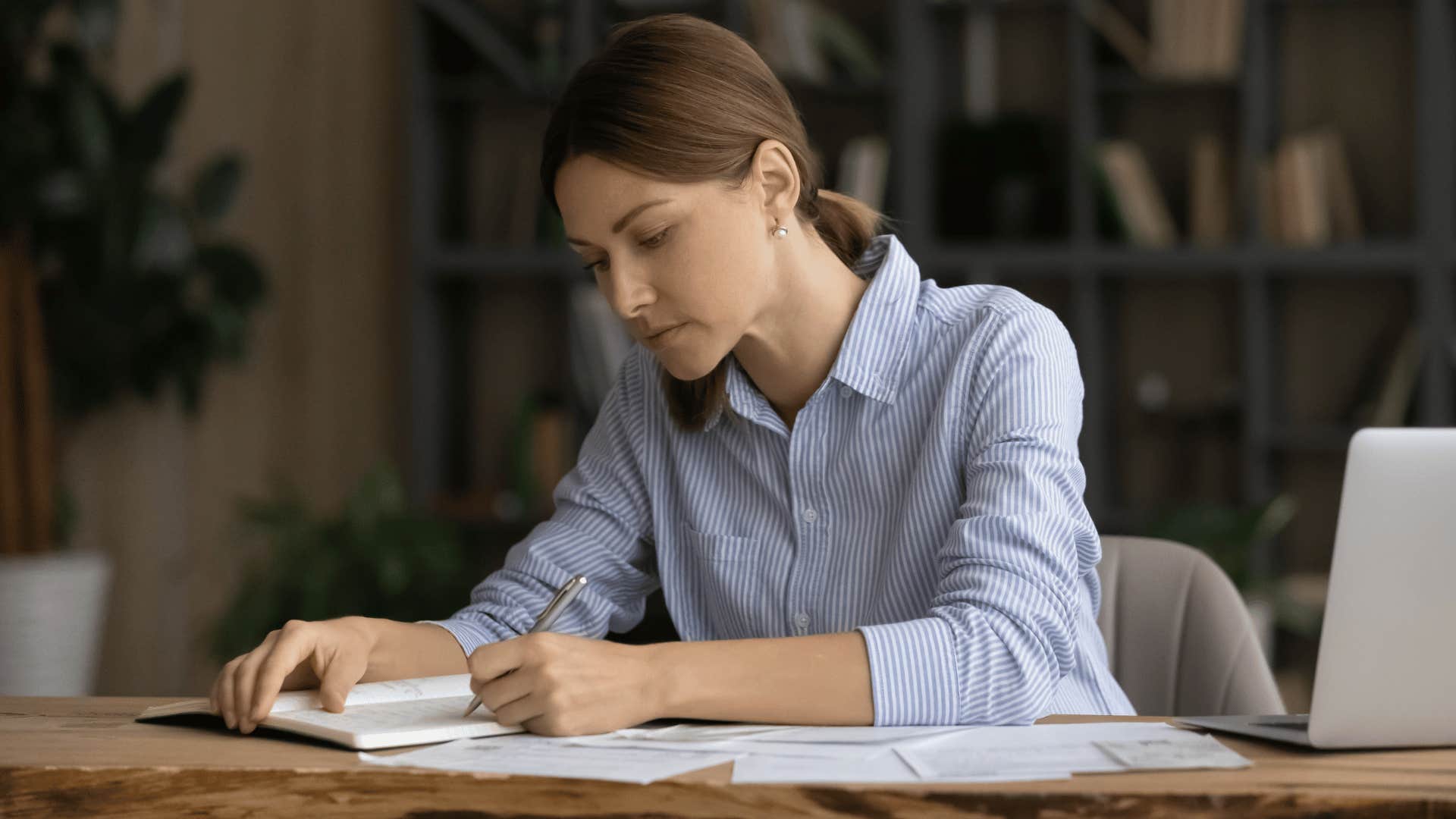 woman writing in notebook