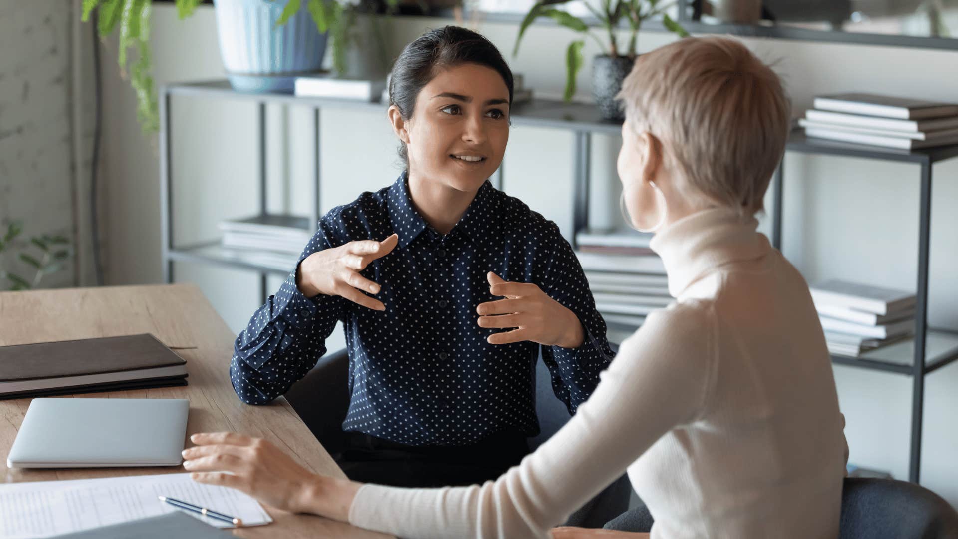 woman explaining something to other woman