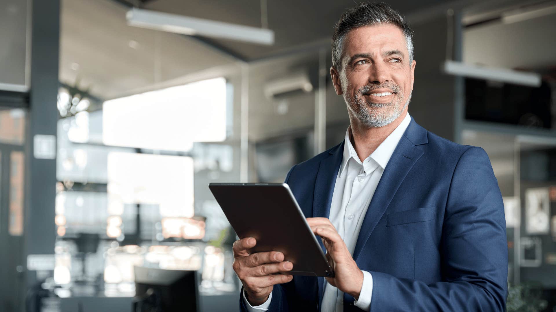 man smiling and on tablet