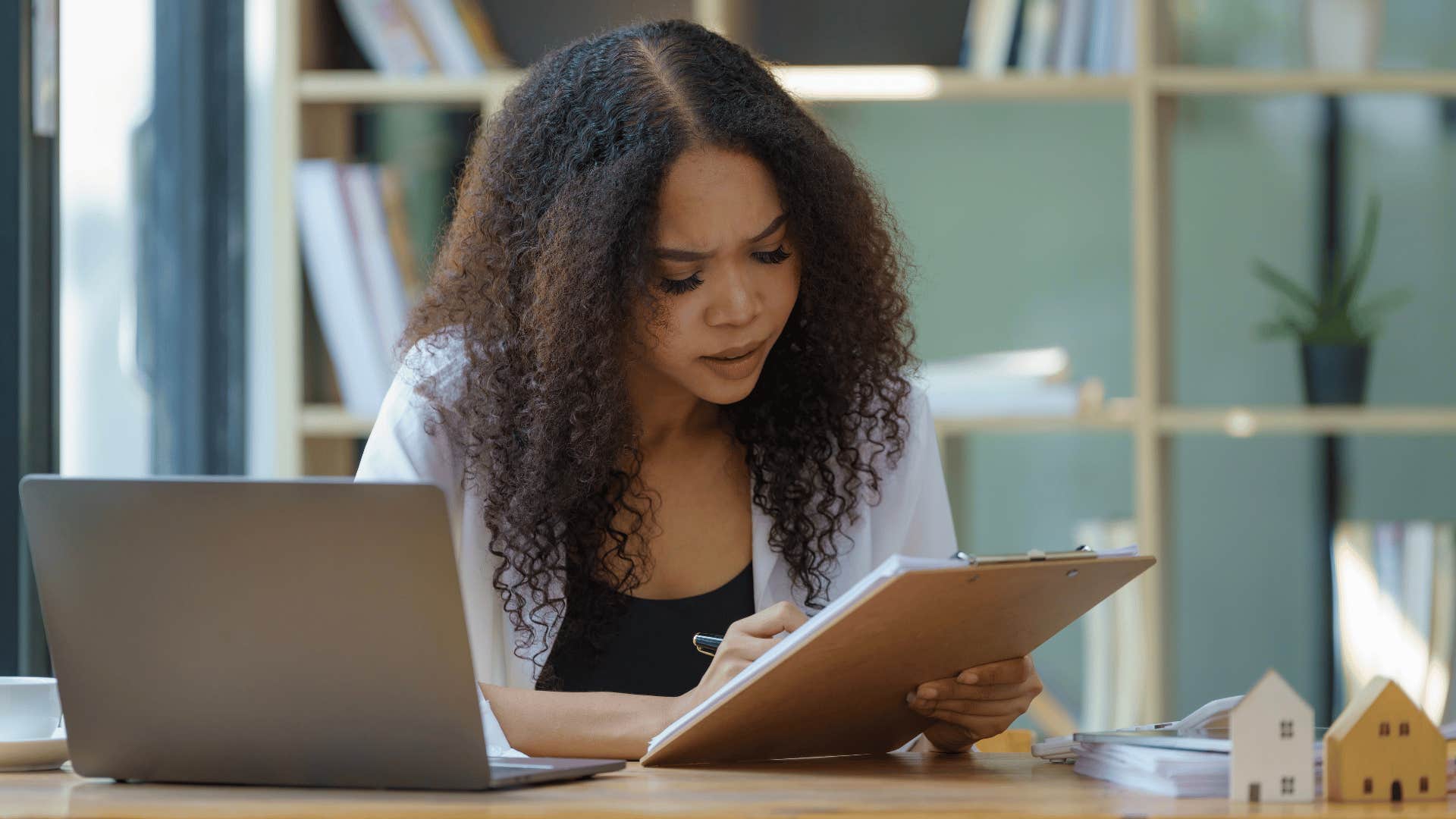 woman looking through notebook